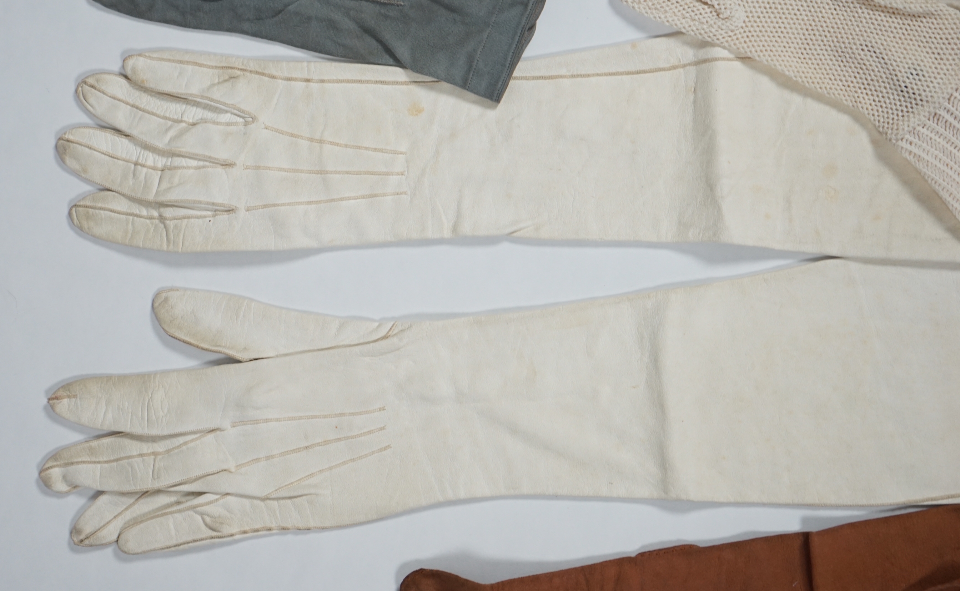 A pair of lady's Hermès skin gloves, boxed and three other pairs of gloves